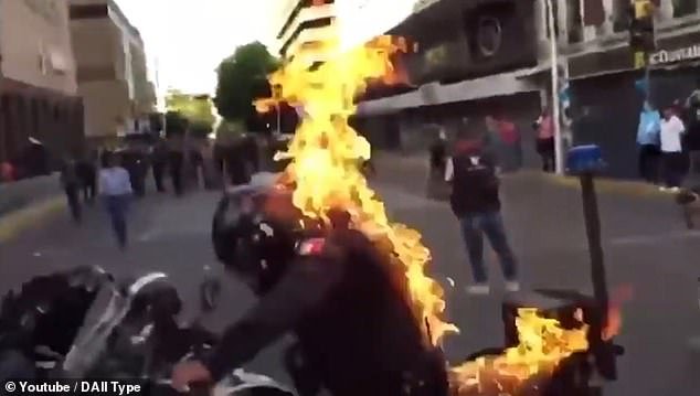 Terrifying moment police officer is set on fire during violent protests in Mexico